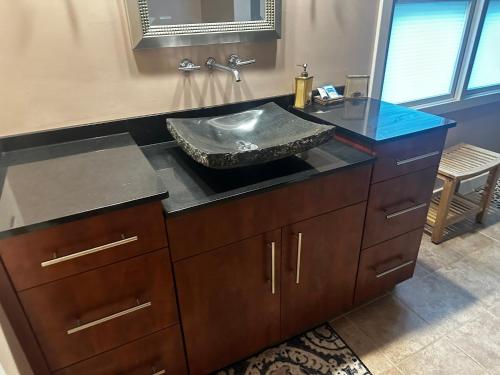 a bathroom with a sink with a granite counter top at Beacon Hill Lake House in Pinnacle