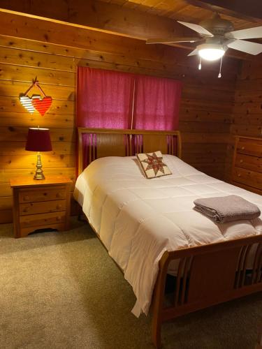 a bedroom with a bed in a log cabin at Beacon Hill Lake House in Pinnacle