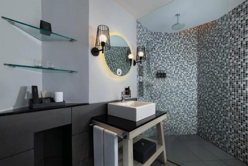 a bathroom with a sink and a mirror at Hard Rock Hotel Bali in Kuta