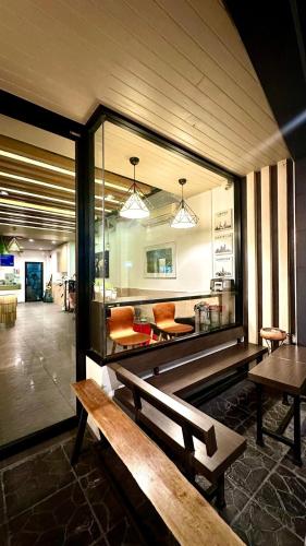 a room with two wooden benches in a building at Daraya Hostel in Bangkok