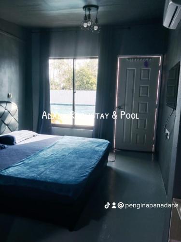 a bedroom with a bed and a window and a door at Adana Homestay & Pool in Kangar