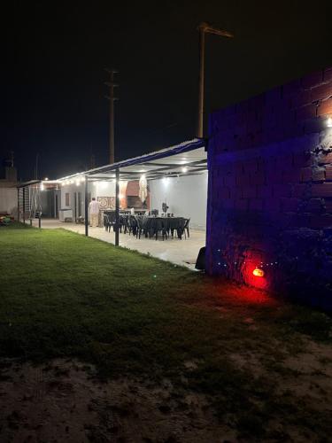 a man standing in a building with cows in a shed at night at El triángulo finca familiar in Maco