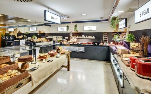 a bakery with a lot of food on display at Sercotel Caspe in Barcelona