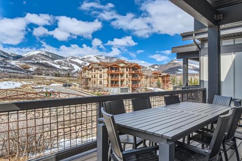 a table on the balcony with a view of the mountains at Helling Circle Hideaway 303 in Heber City