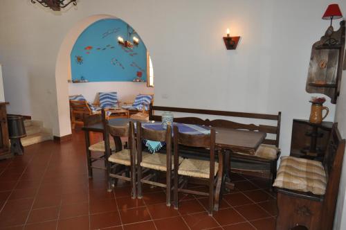 a dining room with a table and chairs at Villa Hibisco in San Vito lo Capo