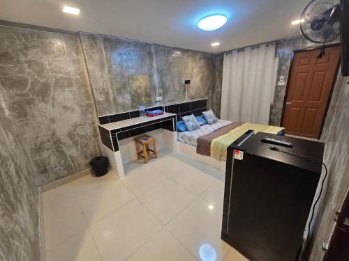 a bedroom with a bed and a desk in it at BB GuestHouse in Ban Zong Katiam
