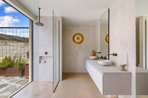 a bathroom with two sinks and a mirror at Pavilion-Style Residence Queenstown in Queenstown