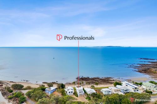 an aerial view of a beach with houses at Waters Edge On Wattle, Absolute Beachfront Luxury in Yeppoon