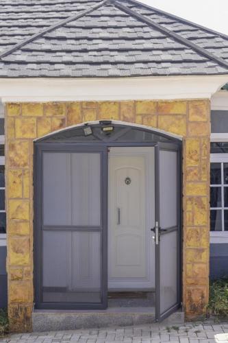 a garage with a white door on a house at Tunjor Homes in Barikin Jirga Summa