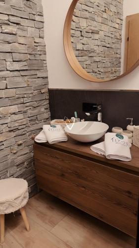 a bathroom with a sink and a mirror at Tiroli in Westendorf