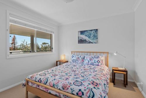 a bedroom with a bed and a window at Foredeck Views in Manyana