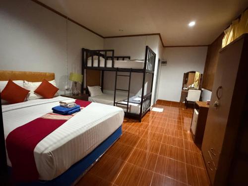 a bedroom with a bed and a bunk bed at Poonsap Resort in Ko Lanta