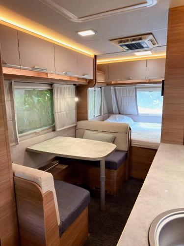 a small room with a table and a sink in it at Canopy Villa Nuang Hill in Bentong