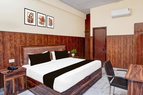 a bedroom with a bed and a desk and a chair at OYO Collection O Govind Vihar Matiyari Formerly Saffron in Lucknow