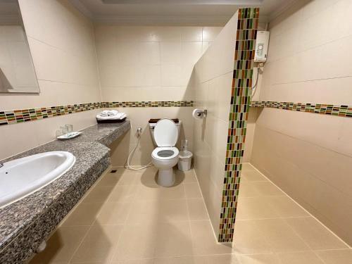 a bathroom with a toilet and a sink at Rattana View in Phitsanulok