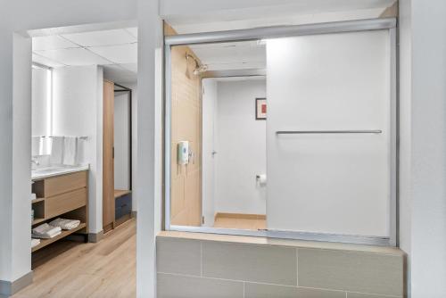 a bathroom with a mirror and a sink at Comfort Suites Bethlehem Near Lehigh University and LVI Airport in Bethlehem