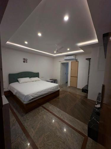 a bedroom with a bed and a ceiling at AMV Airport Residency in Bangalore