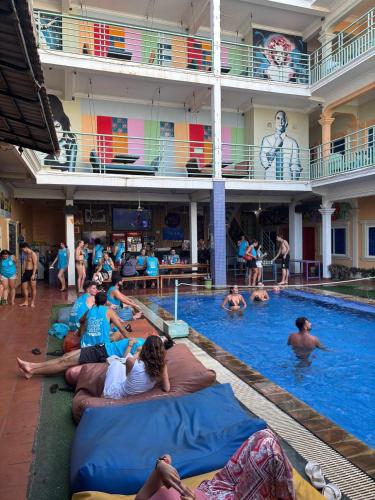a group of people laying in a swimming pool at The Funky Village in Siem Reap