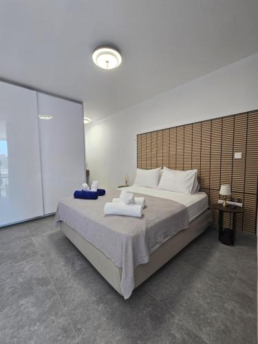 a bedroom with a large bed with towels on it at Divina Loft C Modern Loft with Shared Pool in Perivolia