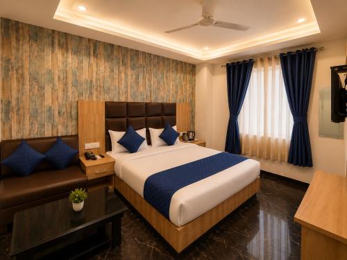 a hotel room with a bed and a couch at Hotel Hyfa Continental in Lucknow
