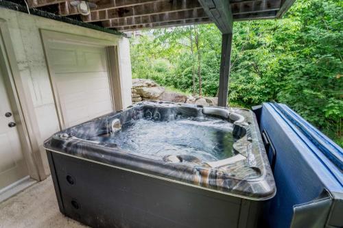 a hot tub in the backyard of a house at Spa Outdoor & Adventure - LEnigmasud in Saint-Philémon