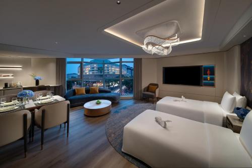 a large living room with a couch and a table at Sunworld Dynasty Hotel Beijing Wangfujing in Beijing