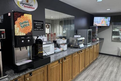 a fast food restaurant with a counter with a popcorn machine at Super 8 by Wyndham Chanute in Chanute