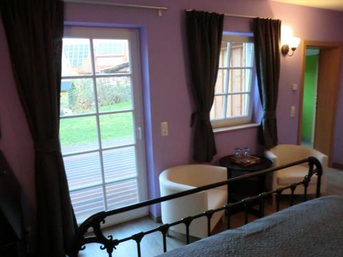 a bedroom with a bed and a large window at The Cosy Home in Hodenhagen