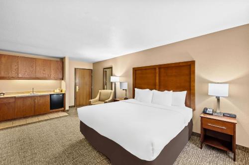 a hotel room with a large bed and a television at Comfort Inn Benson near Kartchner Caverns in Benson