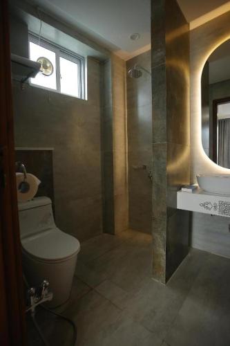 a bathroom with a toilet and a sink at ZAR Luxury Suites in Murree