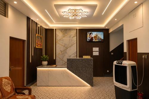 a lobby with a tv on the wall at Hotel Jayaditya Palace in Ayodhya