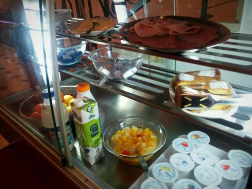 a counter with some food and other foods in a kitchen at Hotel Principe in Udine