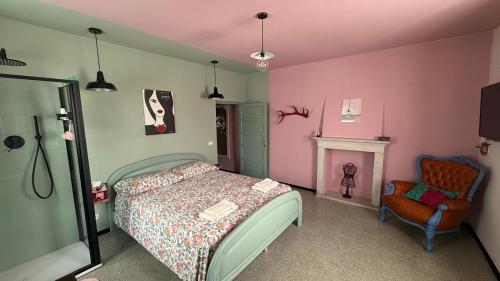 a bedroom with a bed and a chair at Verde Salvia House in Corniglio