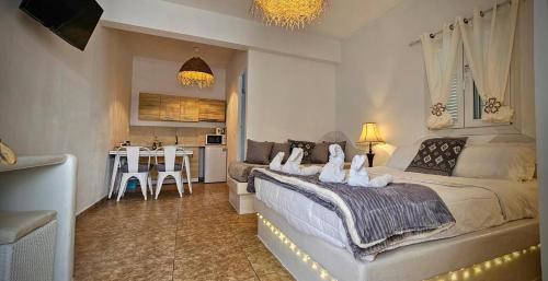 a bedroom with a large bed and a table at Santorini Studios Pleasure in Perissa