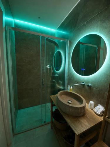 a bathroom with a sink and a glass shower at Vénere maison de charme in Giovinazzo