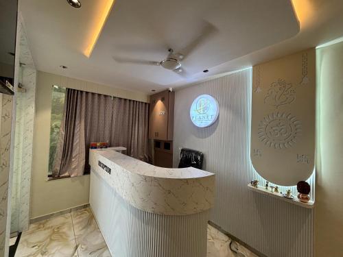 a bathroom with a counter and a mirror on the wall at Hotel Planet Town in Ahmedabad