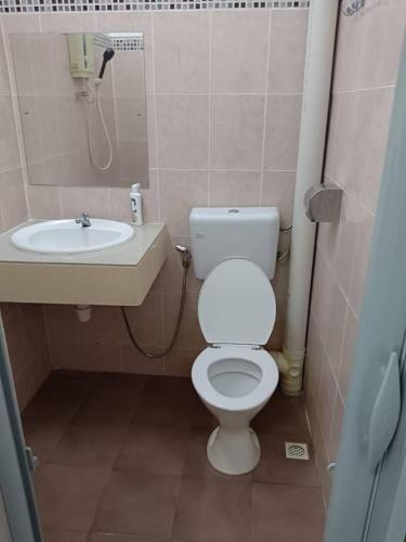 a bathroom with a toilet and a sink at VKB Ferringhi Styles Penang formerly Grand Star Hotel in Batu Ferringhi