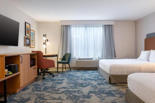a hotel room with two beds and a desk with a computer at Hampton Inn & Suites Prattville in Prattville