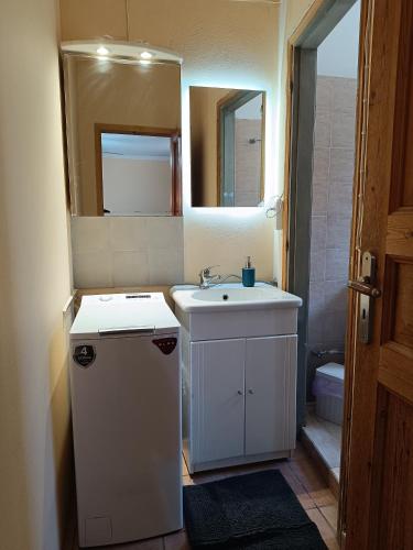 a small bathroom with a sink and a mirror at Seaside olive grove in Pyrgi Thermis