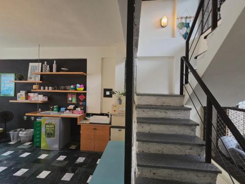 a stairway leading to a kitchen and a kitchen at Avery case in Tainan