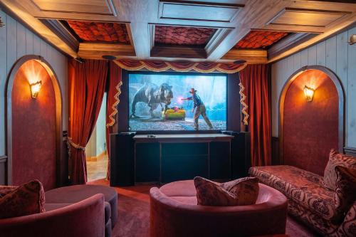 a living room with a large screen with a tv at The Moose House by Juniper Holiday + Home in New Buffalo