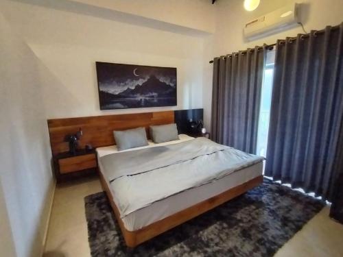 a bedroom with a large bed and a window at Villa 80 in Gonapola