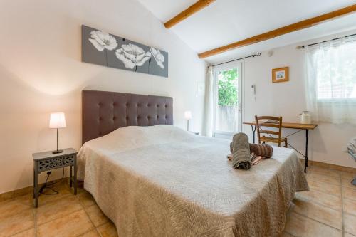 a person laying on a bed in a bedroom at Chambres D'hôtes Les Seignerolles in Pernes-les-Fontaines