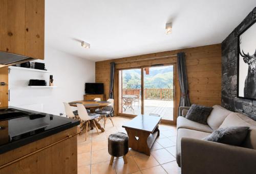 a living room with a couch and a table at Chalet Adele - Appartement 4 personnes situé en bord de piste St Martin de Belleville MAE-5684 in Saint-Martin-de-Belleville