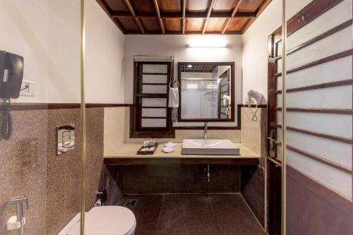 a bathroom with a sink and a toilet at Club Mahindra Cherai Beach, Kochi in Cherai Beach
