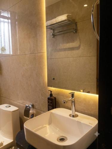 a bathroom with a white sink and a mirror at Hotel 5 Elements By Fidato Hotels in Akalkot