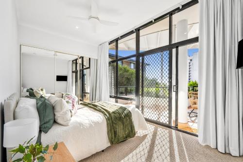 a bedroom with a bed and a large window at Coolum Beach Apartment, 2 Bed 2 Bath, Pool in Coolum Beach