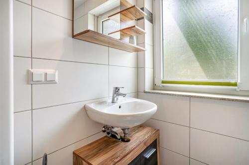 a bathroom with a sink and a window at Haus U13 in Röbel