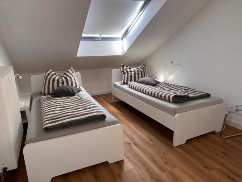 two beds sitting in a room with a skylight at Fewo Bad Salzuflen in Bad Salzuflen
