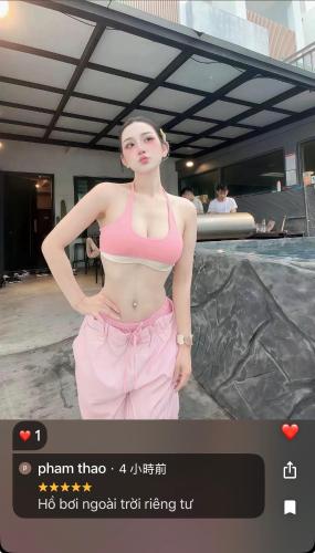 a woman in a pink bikini standing next to a pool at 月出悠悠Moon Rise未與阿勾達合作電聯付訂才算預訂完成 in Hengchun South Gate